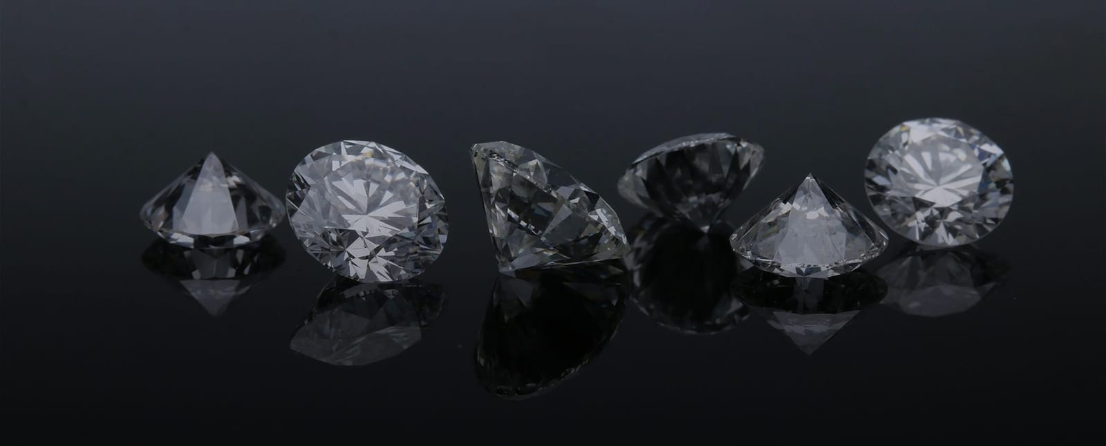 Natural diamonds being inspected under a loupe before setting